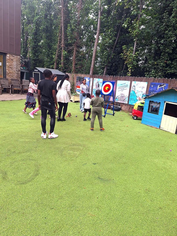 Children playing target games on the lawn at a church family day