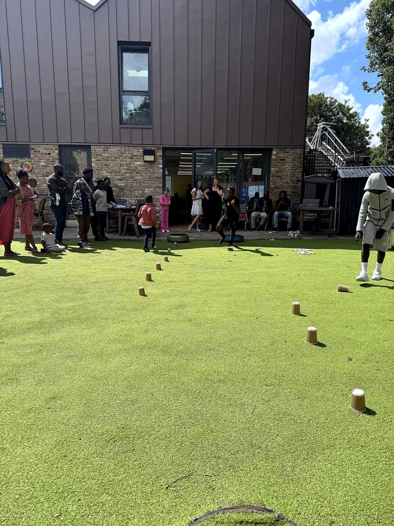 Families gathered outside the building for a summer garden event