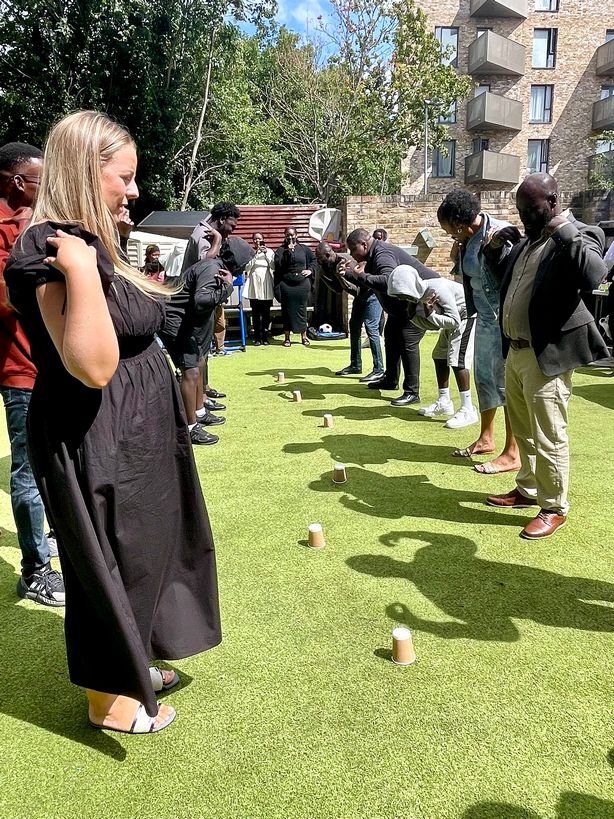 Adults taking part in an outdoor team game on the grass