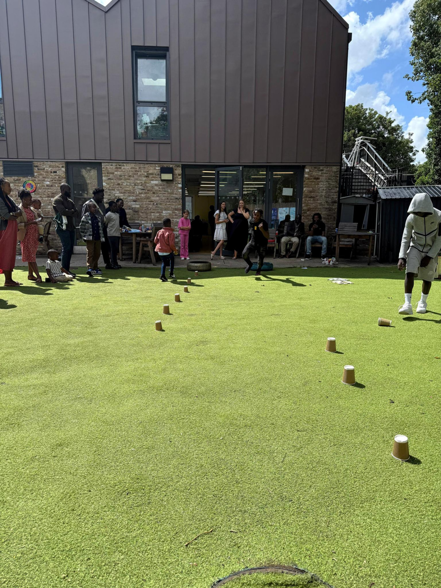 Church members and children enjoying outdoor games on a sunny afternoon